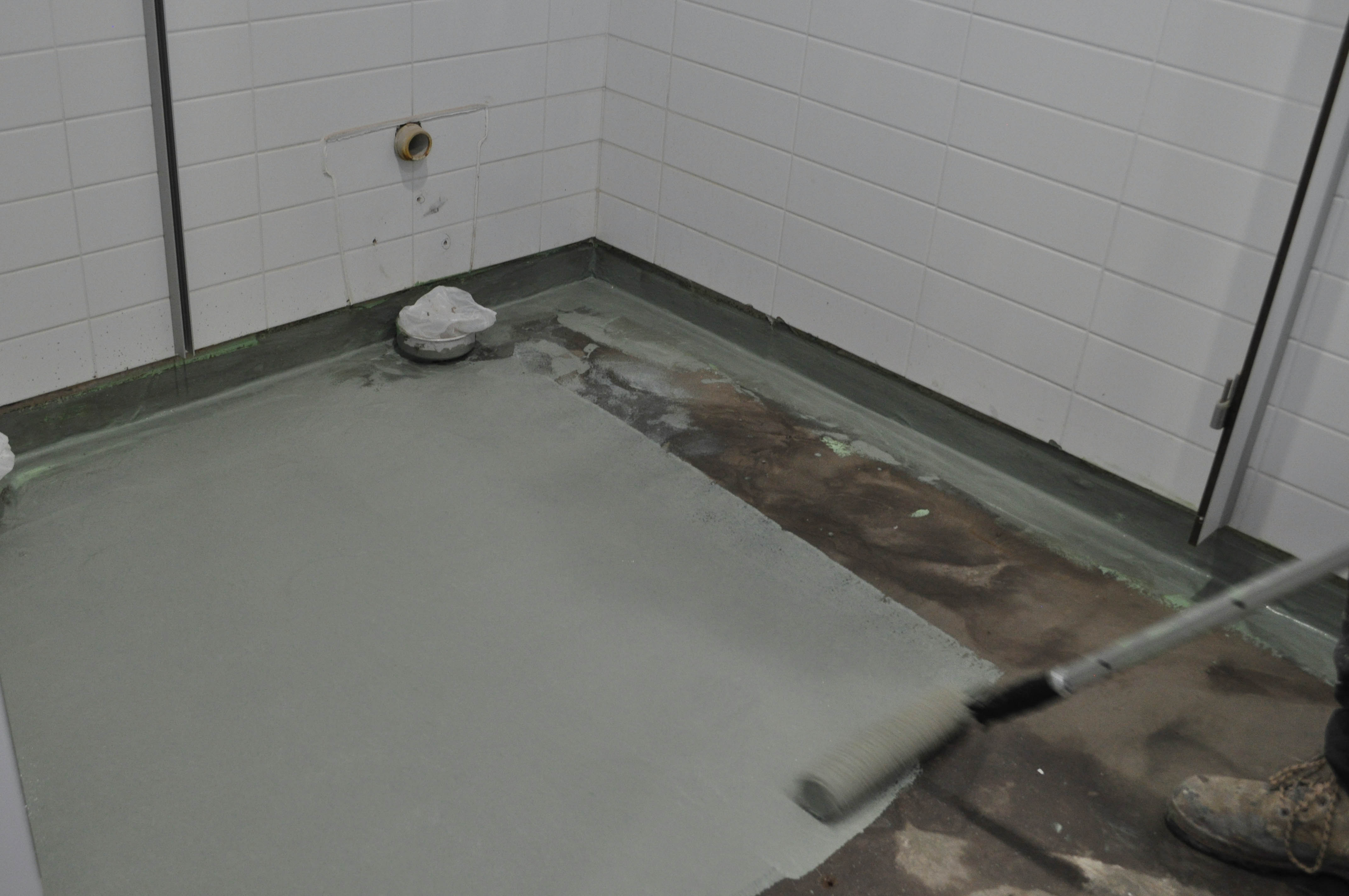 showing a toilet floor in a church that has had floor moisture barrier applied to it.