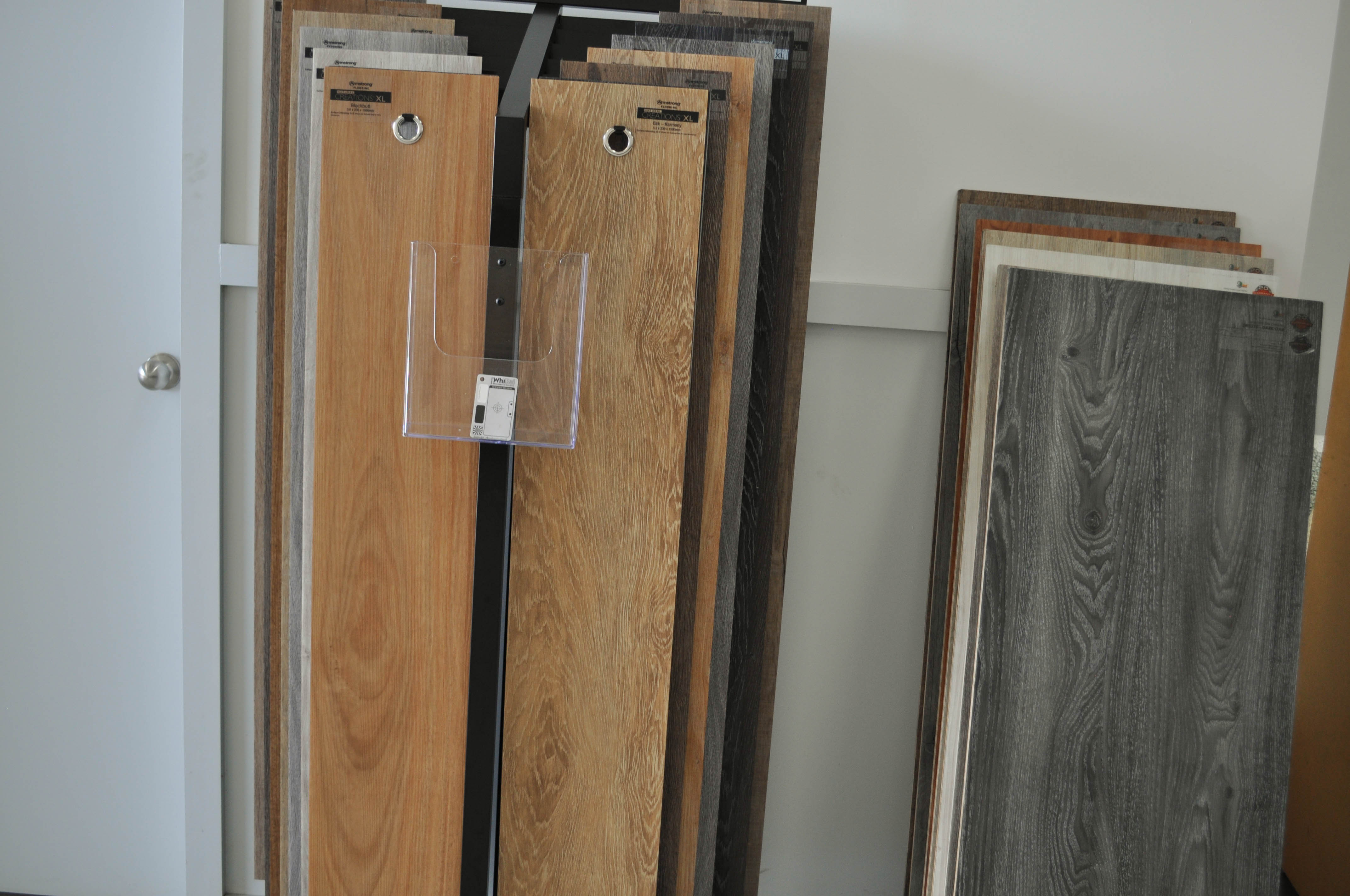 Concord Floor's laminate flooring showroom in Ravenhall, Caroline Springs. It has laminate stands with
 laminate samples on them. The people can come in and select their floor boards here.